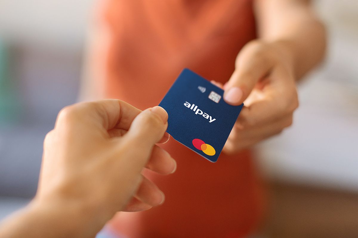 Closeup shot of young woman giving allpay prepaid T&E card to female hand.